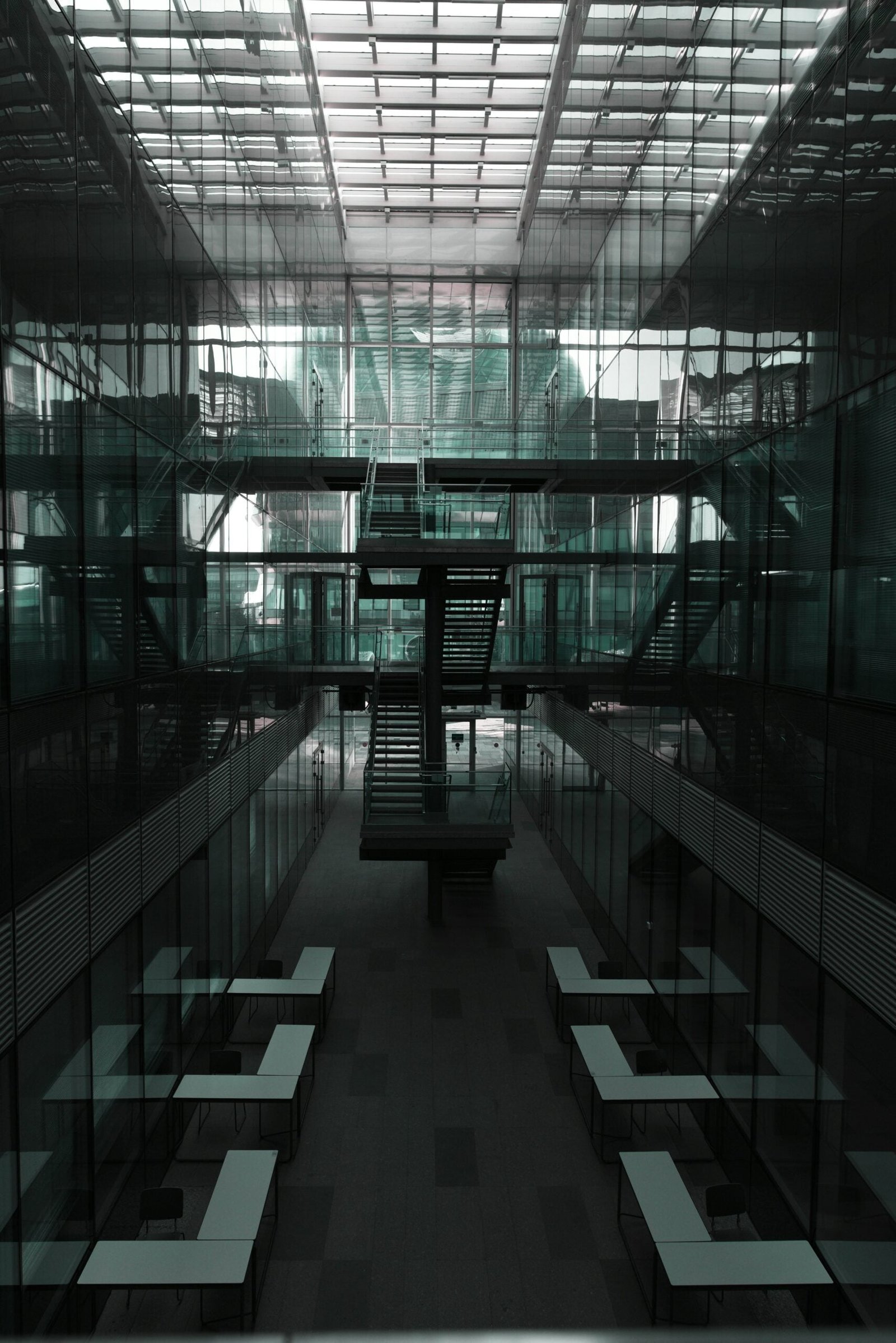 A black and white photo of a bench in a building